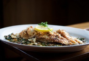sole meuniere on a plate with lemon and parsley