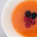 chilled melon soup garnished with fresh berries