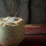 potted cheese in jar on wooden surface