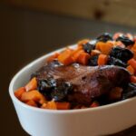 sweet potato and blackberries in a dish with meat