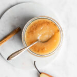 Pear applesauce with cinnamon on a white background