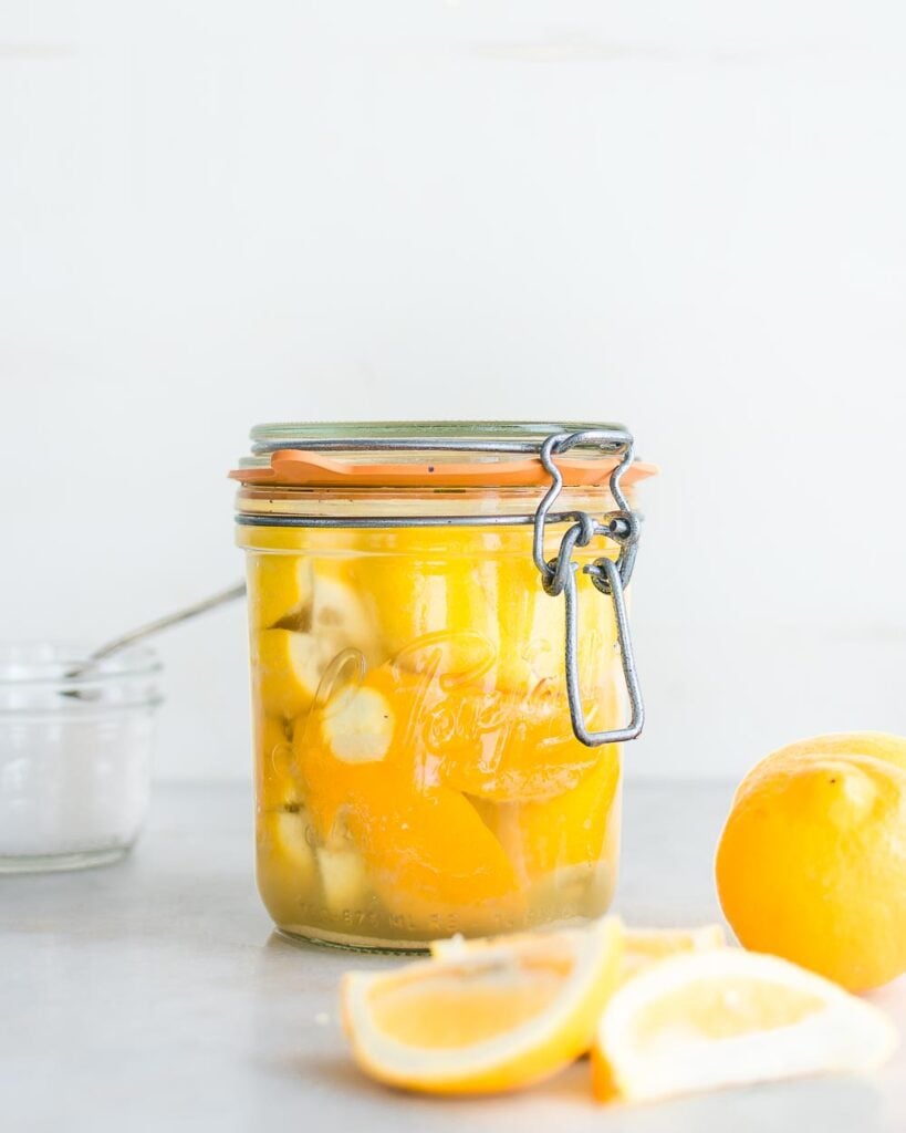 Preserved lemons in a jar made with Meyer lemons and salt.