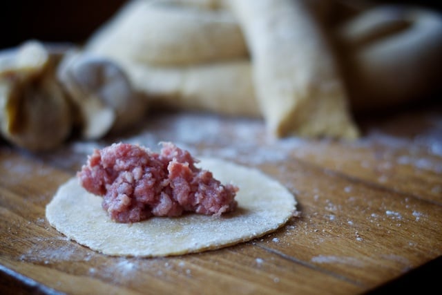 Pelmeni filling in a raw dumpling ready to be filled