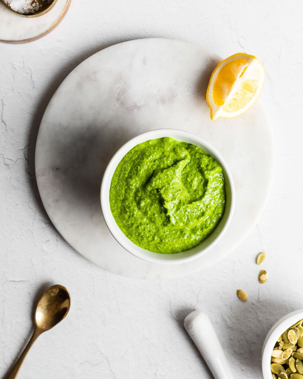 Mustard green pesto in white bowl