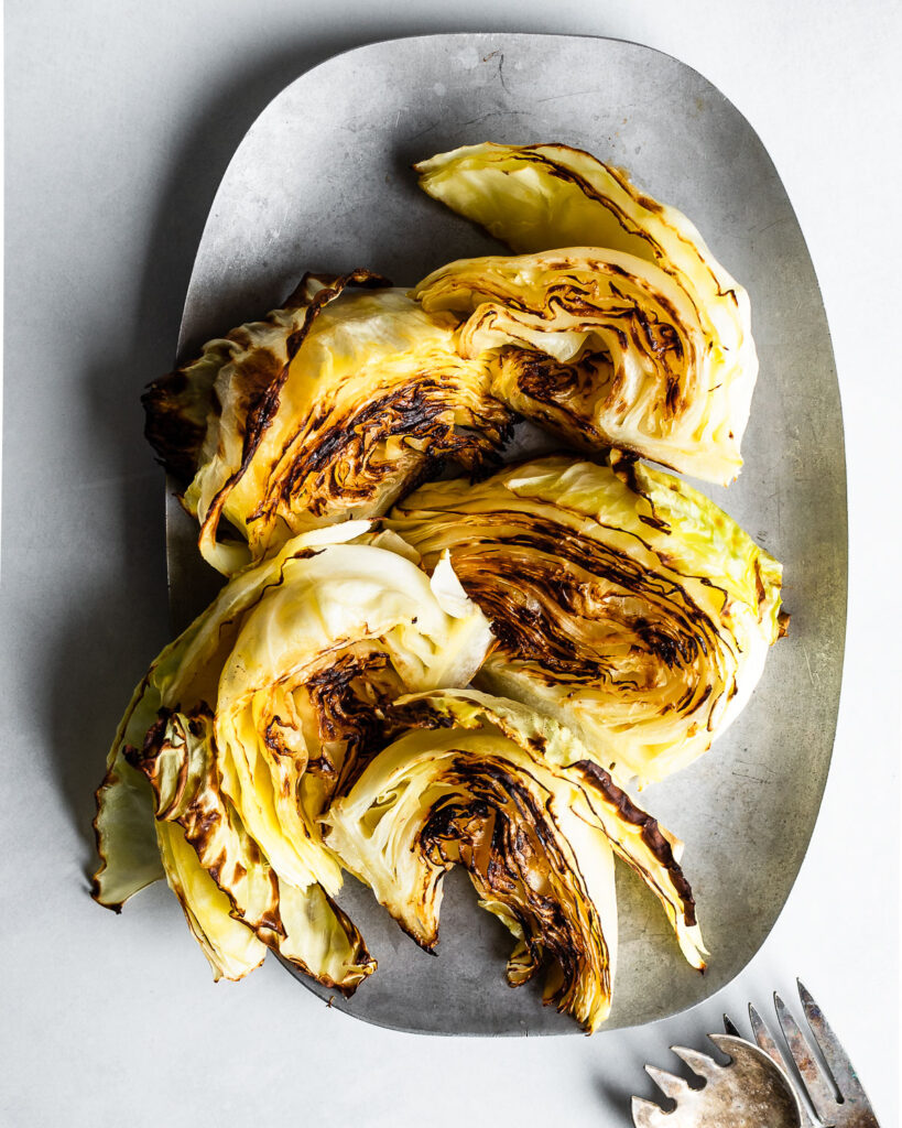 Roasted cabbage wedges on a pewter plate