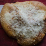 sourdough flat bread dusted with parmesan cheese