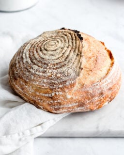 sourdough bread on a white background with flower in a container