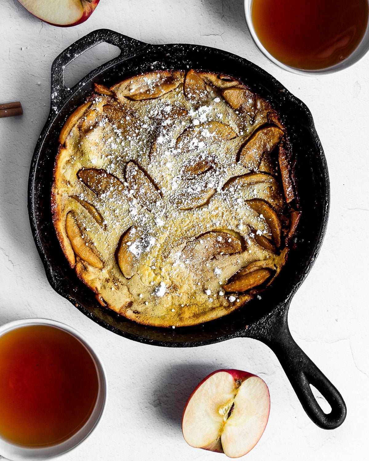 Apple Dutch Baby Pancake Dusted with Powdered Sugar and Served with Tea