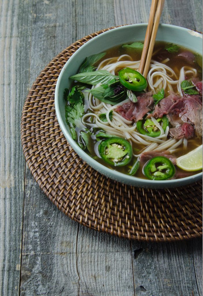 Quick beef pho in a bowl, garnished with basil and jalapenos