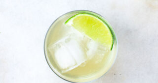 water kefir in a glass with ice and lime