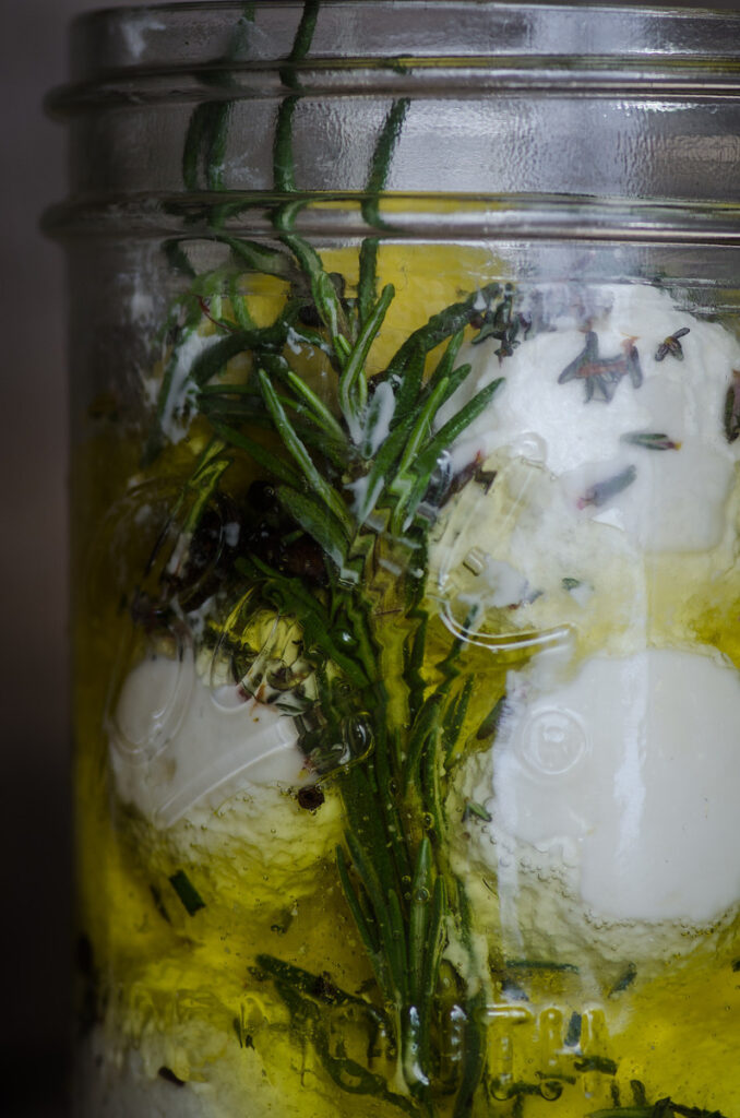 Labneh in a jar of olive oil with rosemary