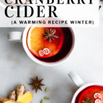 pinterest pin of cranberry cider with spices in a pot