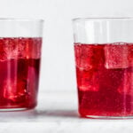 two cups of elderberry kombucha with ice