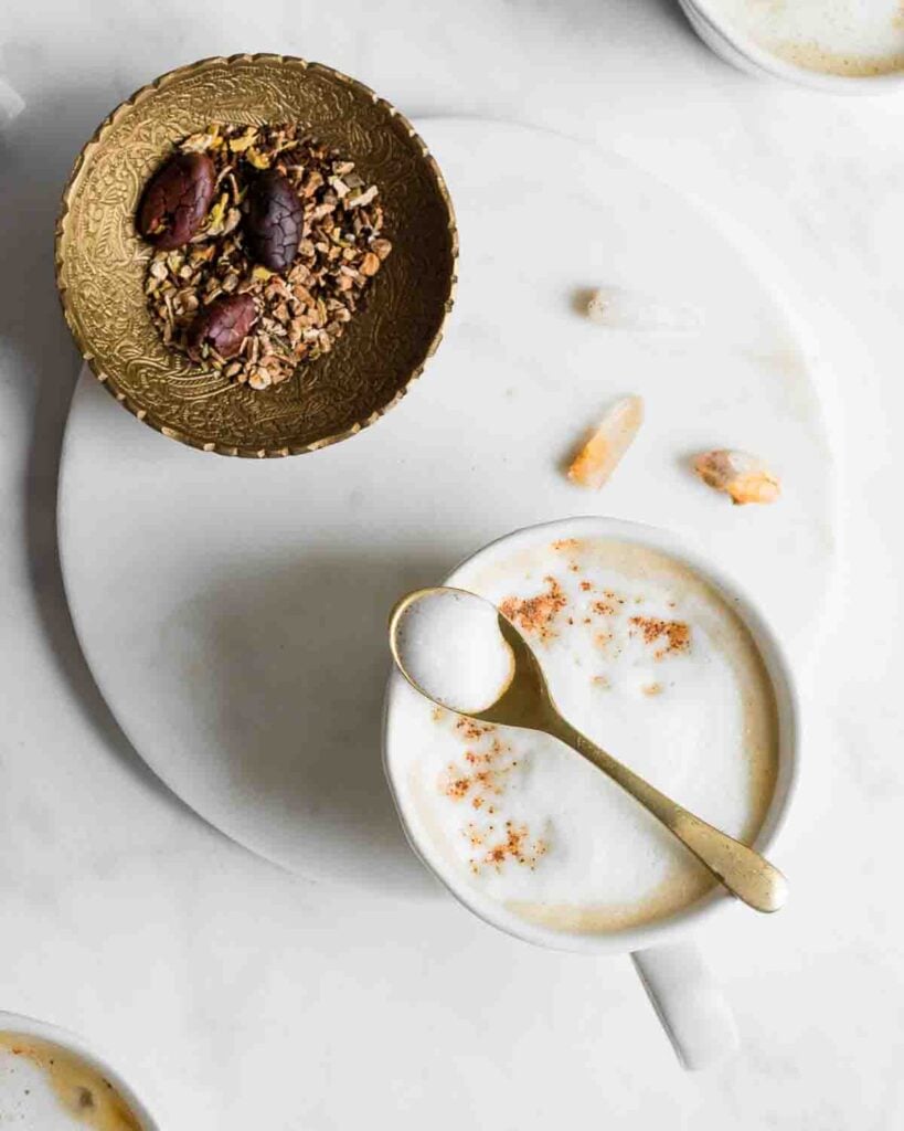 Dandelion mocha in a mug on a marble tray.