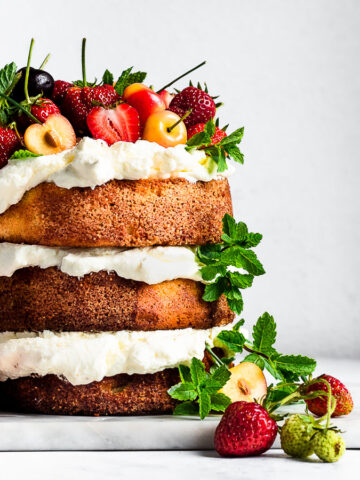 almond cake with cherries, strawberries and mint
