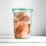 Himalayan pink rock salt in a glass with water