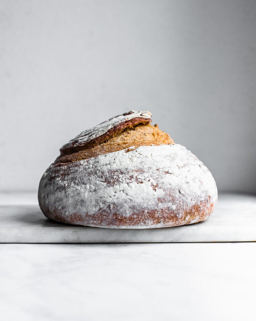 sourdough rye bread boule on a white background