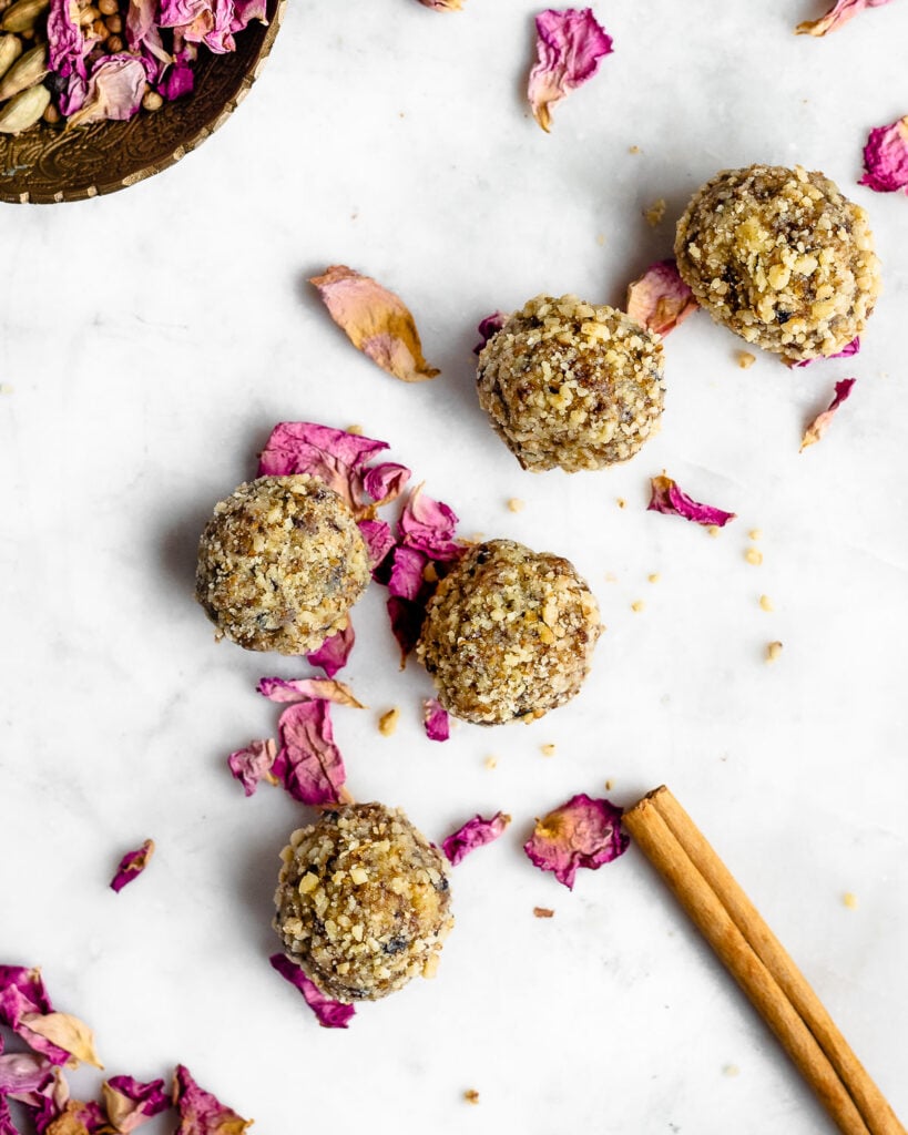 Majoun candy on a marble board garnished with rose petals and cinnamon.