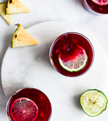 Lime raspberry drink with pinapple on white background