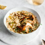 wild mushroom risotto in bowl garnished with thyme
