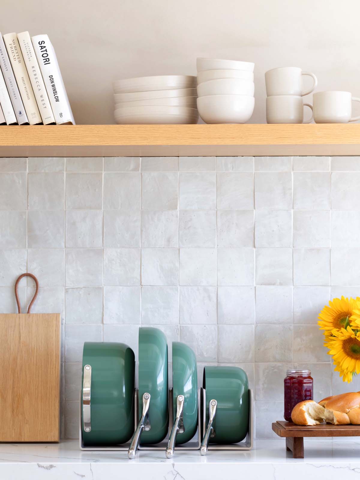 Green Caraway cookware in magnetic organizers on marble counter