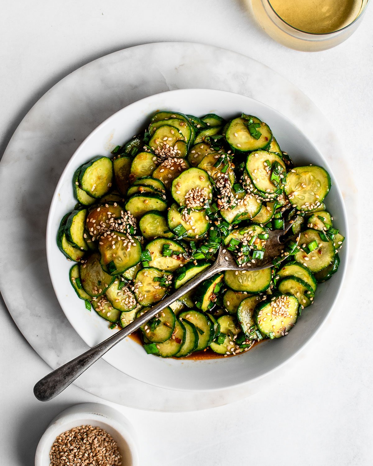 Asian Style Cucumber Salad garnished with garlic chives and sesame seeds