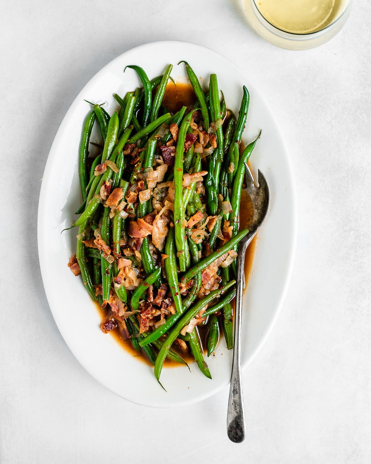 Green Beans with Bacon on a white plate