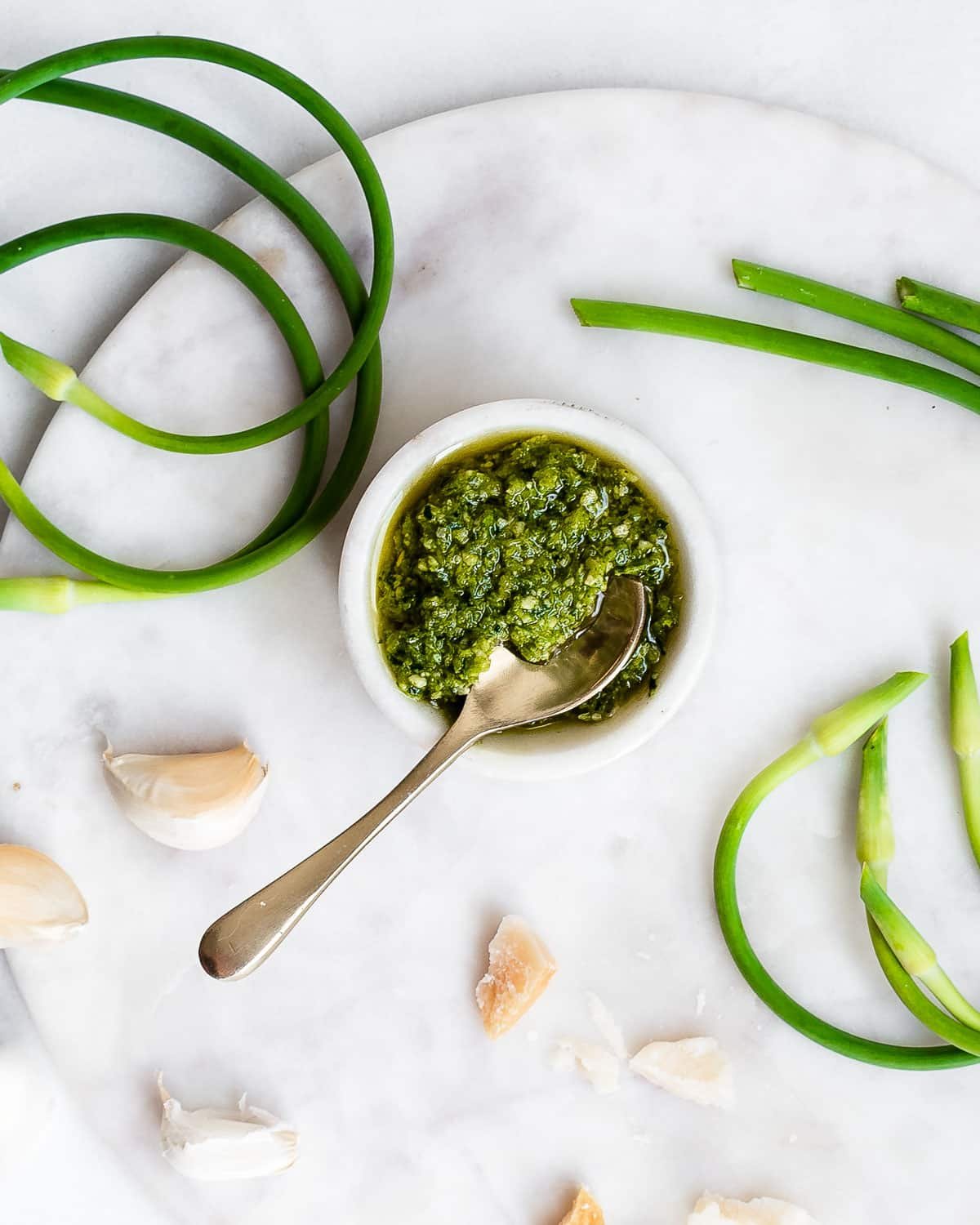 garlic scape pesto on marble surface