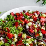 Tomato cucumber salad in white bowl