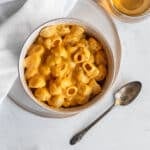 Pumpkin-chipotle mac and cheese in a bowl on a white surface