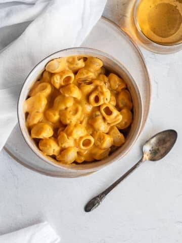 Pumpkin-chipotle mac and cheese in a bowl on a white surface