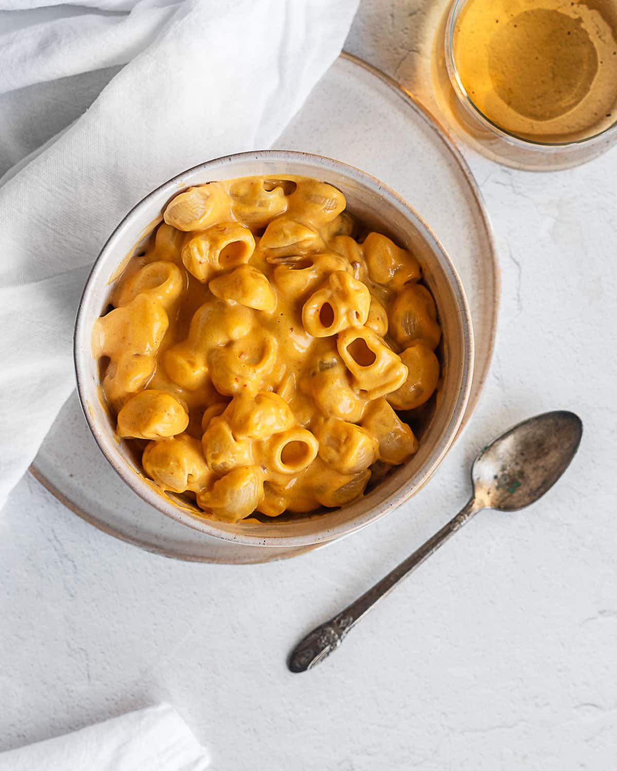 Pumpkin-chipotle mac and cheese in a bowl on a white surface