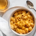 Pumpkin-chipotle mac and cheese in a bowl on a white surface