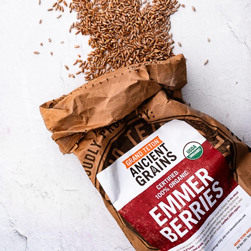 Emmer berries spilling from a brown paper bag labeled