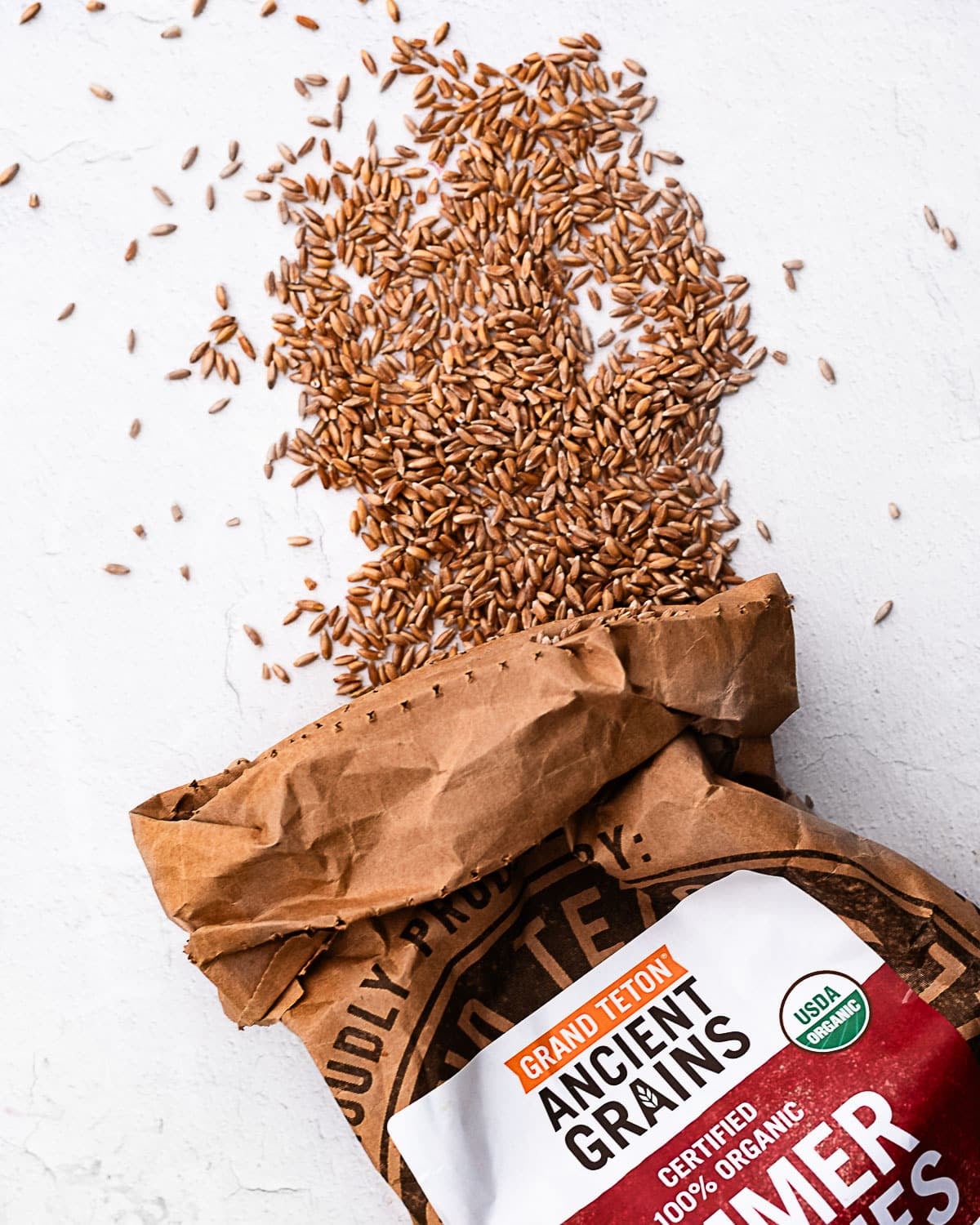 Emmer berries spilling out of a brown paper bag labeled
