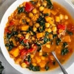 winter minstrone in a white bowl on a white surface