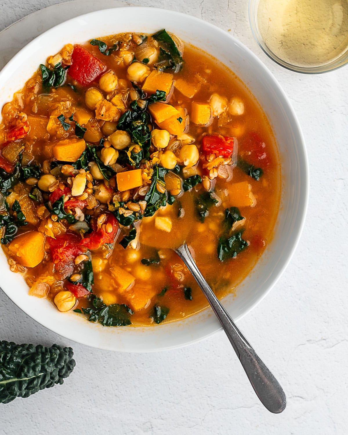 winter minstrone in a white bowl on a white surface