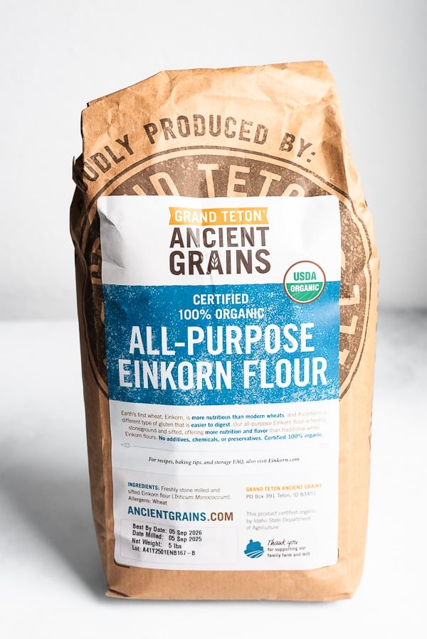 Emmer berries spilling out of a brown paper bag labeled
